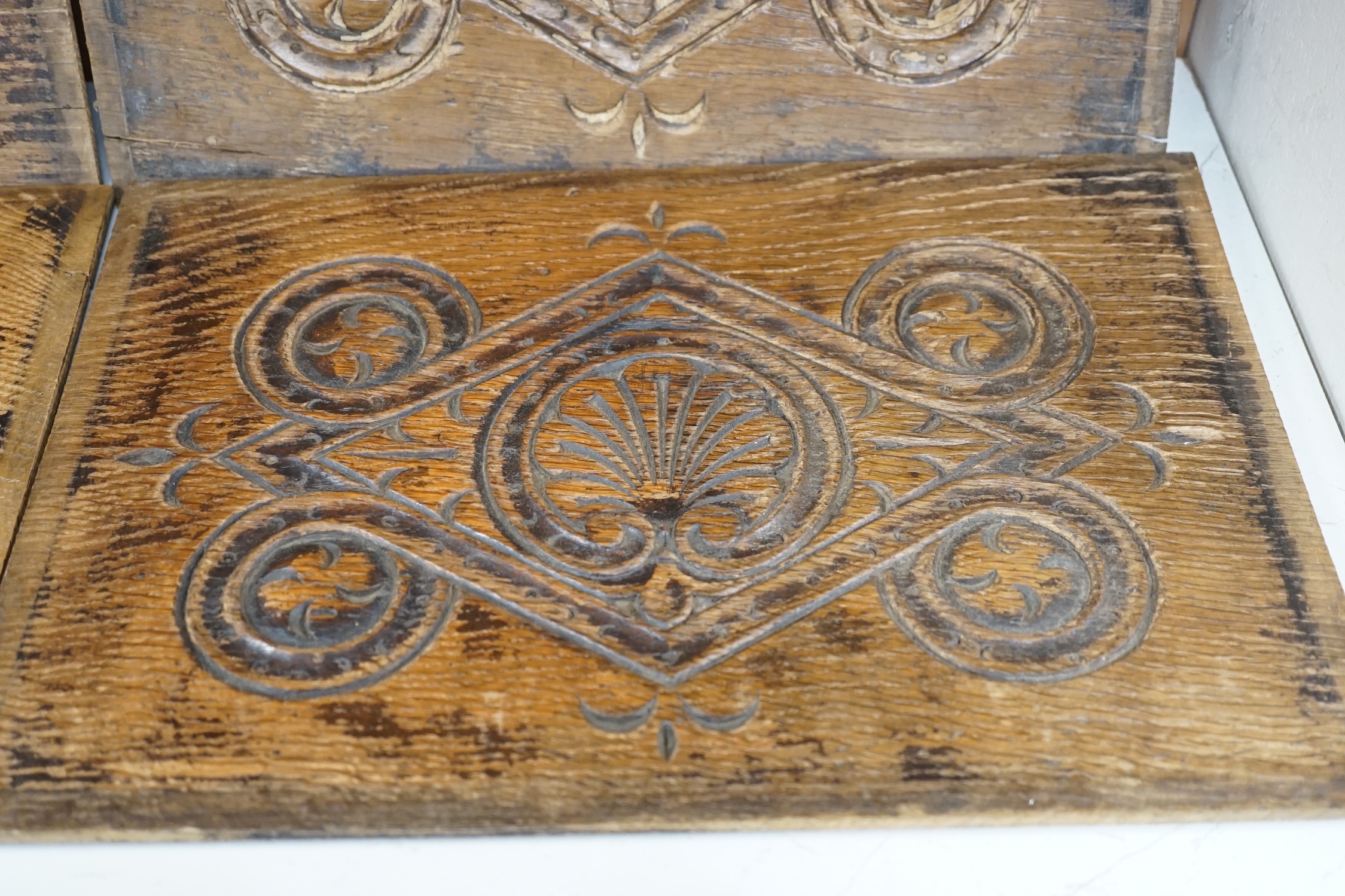 A set of four 18th century carved oak panels, 37cm x 25cm. Condition - two have splits